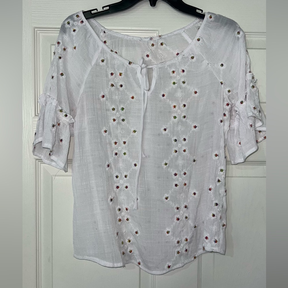 White blouse ruffled sleeves with colored eyelet design